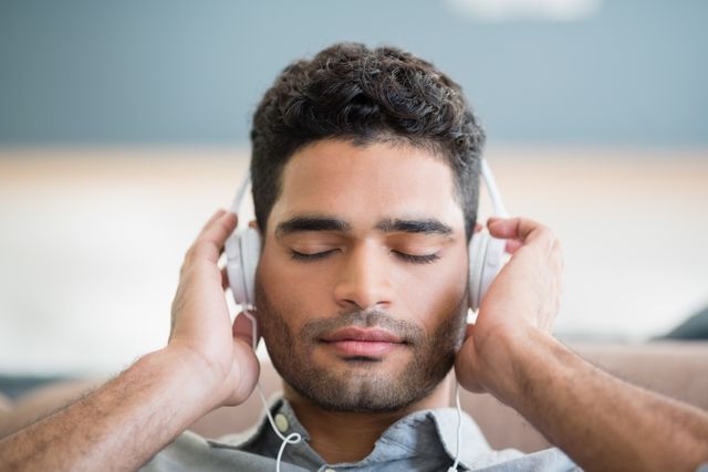 Man Relaxing with Headphones in Living Room - Download Free Stock Photos Pikwizard.com