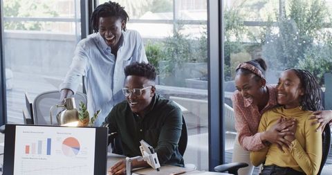 Joyful Team Collaborating on Project in Modern Office Environment
