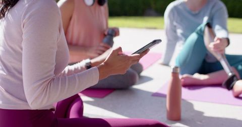 Diverse Women Exercising Outdoors Using Smartphone and Fitness Gear