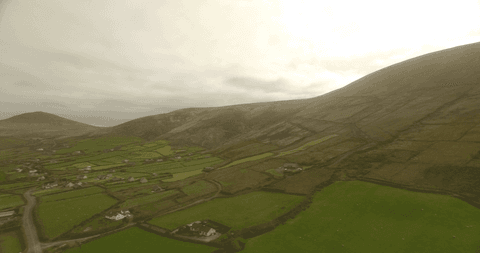 tranquil hillside landscape with lush green fields and overcast sky - Download Free Stock Videos Pikwizard.com
