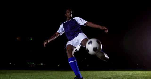 Soccer Player Kicking Ball at Night on Field - Download Free Stock Images Pikwizard.com