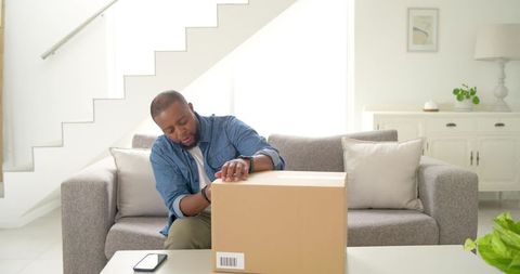 Opening Smart Package While Tapping Phone, Mobile Commerce Unboxing in Modern Living Room