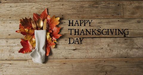 Thanksgiving Celebratory Setup with Autumn Leaves and Cutlery