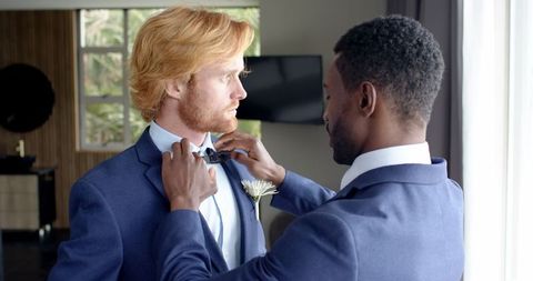 Groom and best man preparing for wedding ceremony together