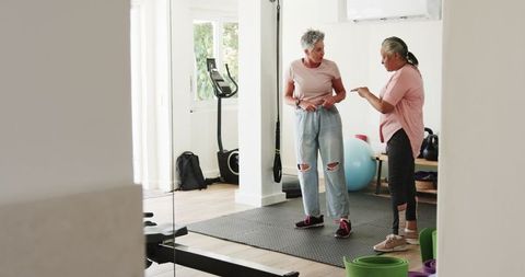 Senior Lesbian Couple Enjoying Workout Together in Home Gym