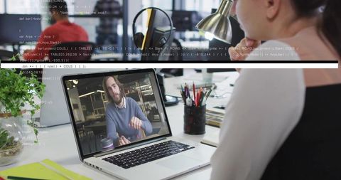 Professional Engaged in a Remote Video Conference in Modern Office Space