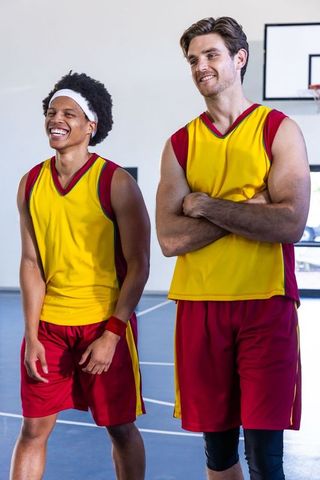Diverse male teammates bonding on court in matching sportswear