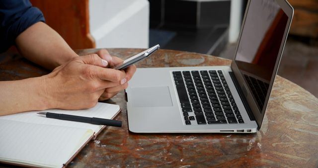 Person Working Remotely with Laptop and Smartphone at Coffee Shop - Download Free Stock Images Pikwizard.com