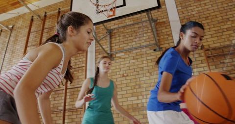 Teenagers Playing Basketball Focused on Skill Development