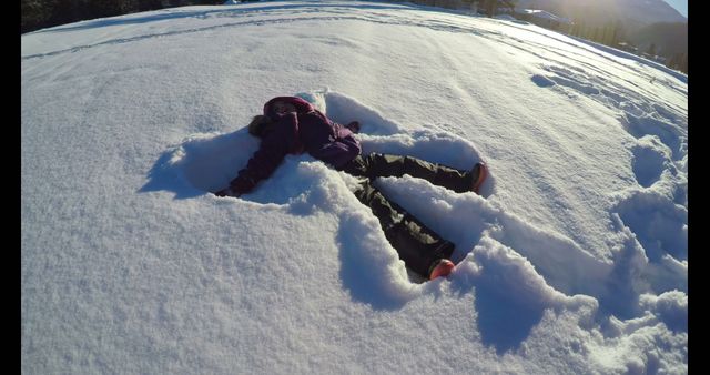 Child Making Snow Angel on Winter's Day - Download Free Stock Images Pikwizard.com