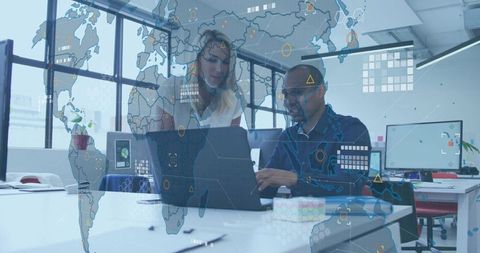 Team collaborating on laptop with holographic world map overlay in bright modern office
