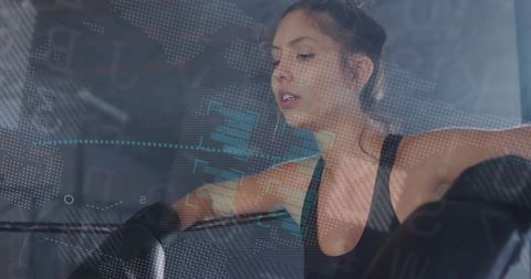 Female boxer resting with digital data overlay in gym environment