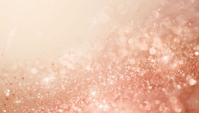 Rose gold glitter bokeh background with shimmering sparkle and soft peach glow