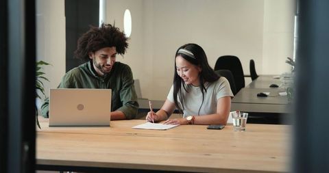 Diverse Coworkers Collaborate on Workspace Project