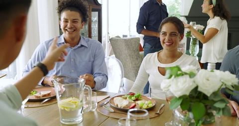 Friends Enjoying a Lively Meal Together at Home
