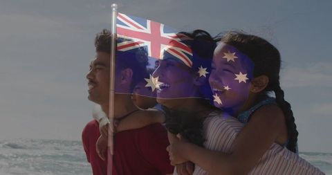 Family celebrating australia day at beach with australian flag overlay and joyful faces