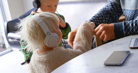 Children with Headphones Enjoying Music Together at Home