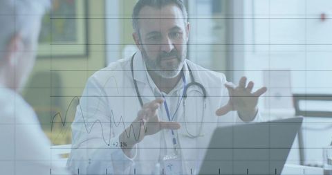 Physician pointing at laptop explaining patient health trends with interactive charts