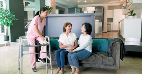Senior Women Engaging with Nurse in Modern Home Environment