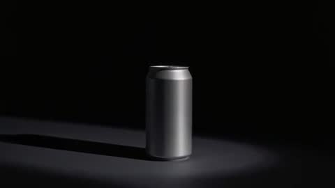 Silver Aluminum Can Rotating in Minimalist Studio with Spotlight