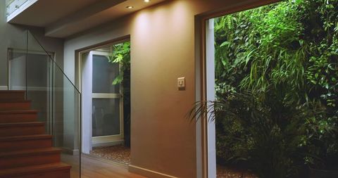 Contemporary Interior with Vertical Garden and Glass Staircase