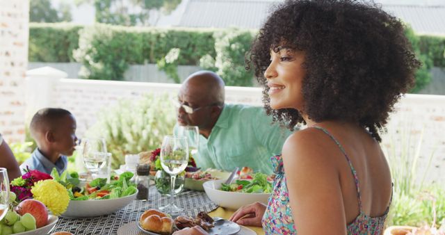 Image of african american family spending time together and having dinner outside. Family life, spending time together with family.