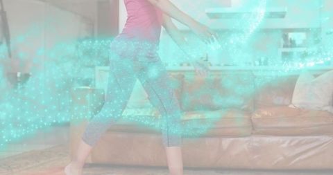 Woman walking through living room with turquoise digital particle swirl for wellness
