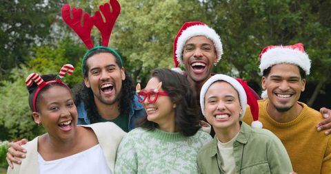 Diverse Friends Smiling in Festive Christmas Accessories Outdoors