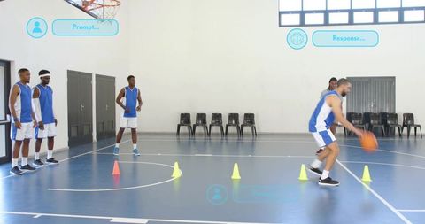 Team practicing dribbling drill with cones on indoor basketball court during training