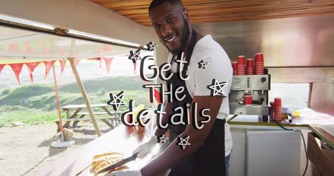 Food truck vendor preparing sausages at outdoor event
