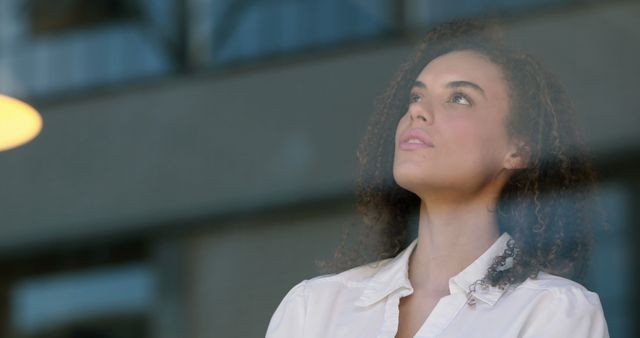 Pensive Woman Looking Through Window in Office - Download Free Stock Images Pikwizard.com