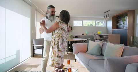 Senior Couple Dancing Joyfully in Bright Living Room