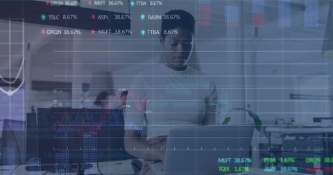 Businesswoman analyzing financial graphs on laptop in modern office