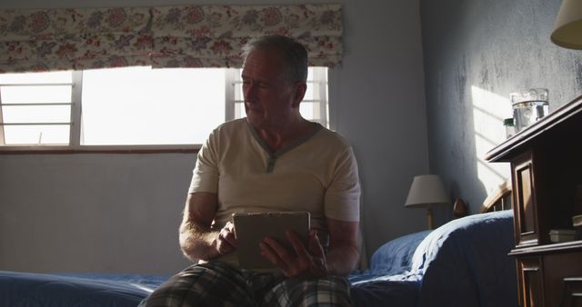 Senior Man Using Digital Tablet in Sunlit Room - Download Free Stock Images Pikwizard.com