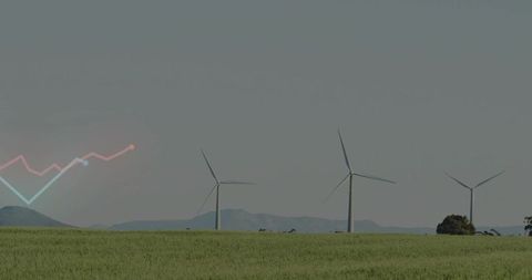 Wind turbines on green plain with line-chart overlay representing renewable energy growth