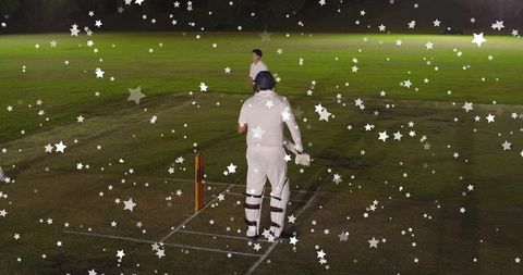 Helmeted batsman standing at crease under floodlights with festive star overlay