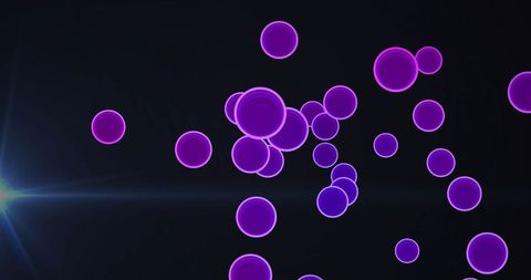 Floating Neon Circles Illuminated Against Black Background with Lens Flare