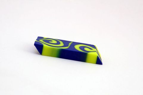 Blue and yellow swirled resin block on white background