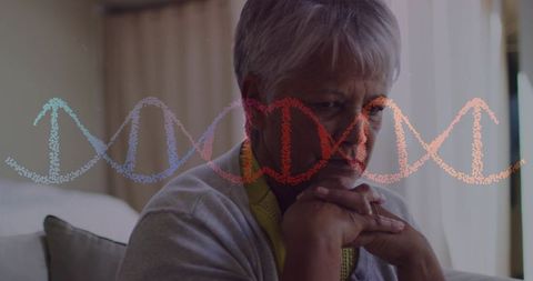 Senior woman contemplating genetic testing and family health with dna helix overlay at home
