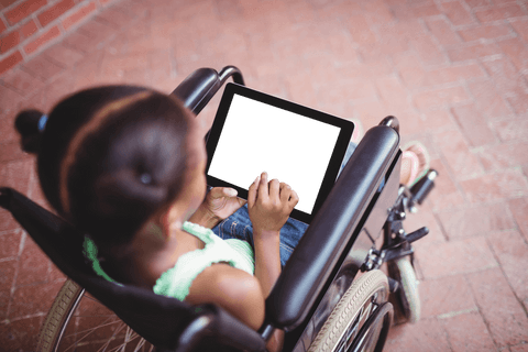 young girl in wheelchair using transparent tablet outdoor - Download Free Stock Videos Pikwizard.com