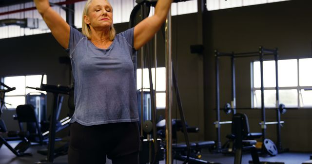 Senior Woman Exercising in Modern Gym - Download Free Stock Images Pikwizard.com