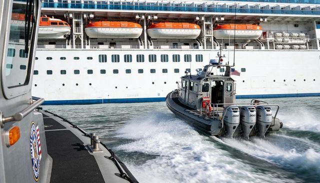 Coast guard patrol boat racing past cruise ship with triple 300 outboards