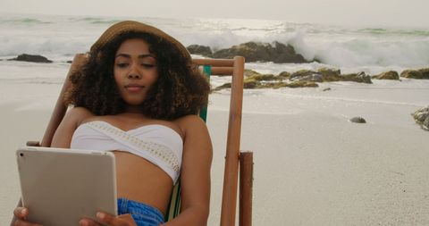 Young Woman Relaxing with Tablet on Scenic Beach - Download Free Stock Images Pikwizard.com