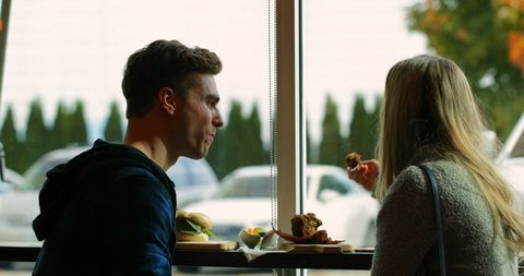 Young Couple Enjoying Meal in Cozy Café