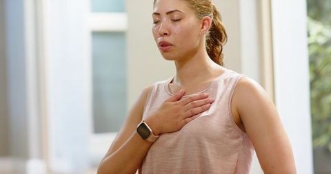 Practicing mindful breathing with smartwatch monitoring for wellness and stress relief