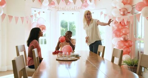 Friends Decorating with Balloons for a Bright Home Celebration