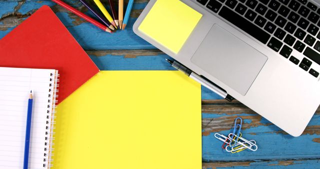 Organized Workspace with Laptop and Colored Stationery - Download Free Stock Images Pikwizard.com