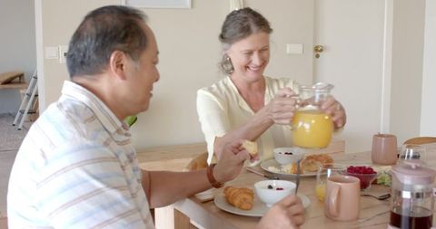 Senior Couple Enjoying Cozy Breakfast at Home