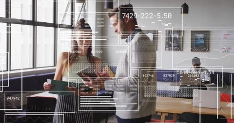 Professionals Reviewing Data on Screen in Modern Office