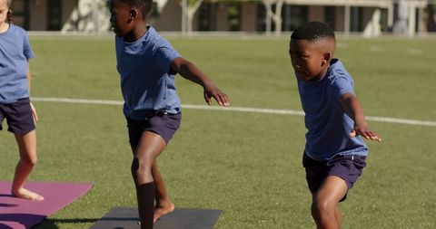 Children Practicing Balance and Yoga on School Field During Outdoor PE Class